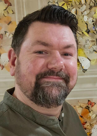 A headshot of Search Beef podcast host Joss Froggatt